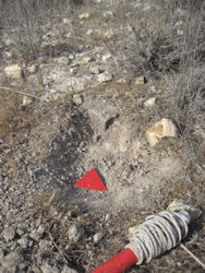 A deminer leaves a suspicious reading/find clearly marked for his Team